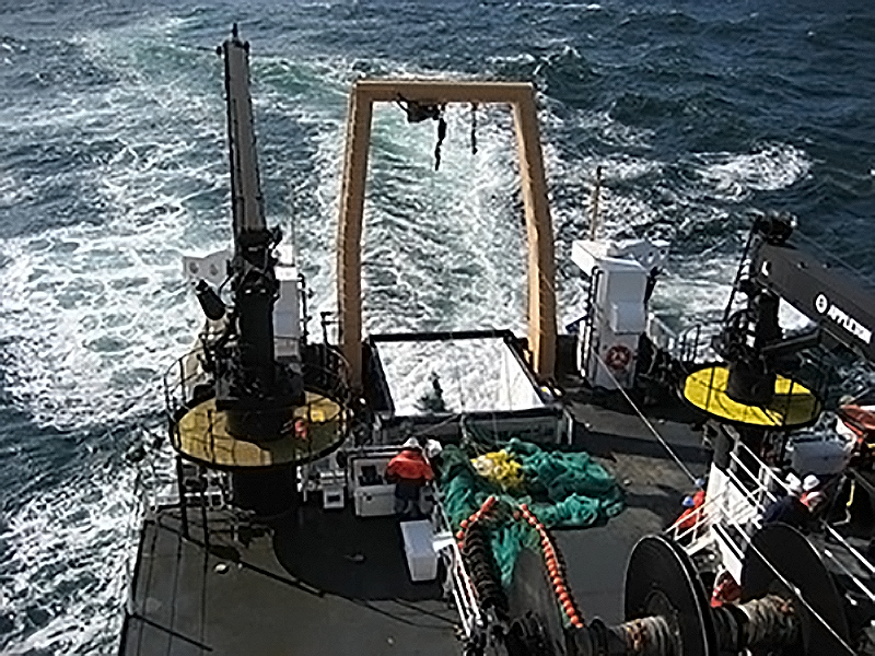 rear deck of a research vessel with net deploying, taken from the second deck of the vessel