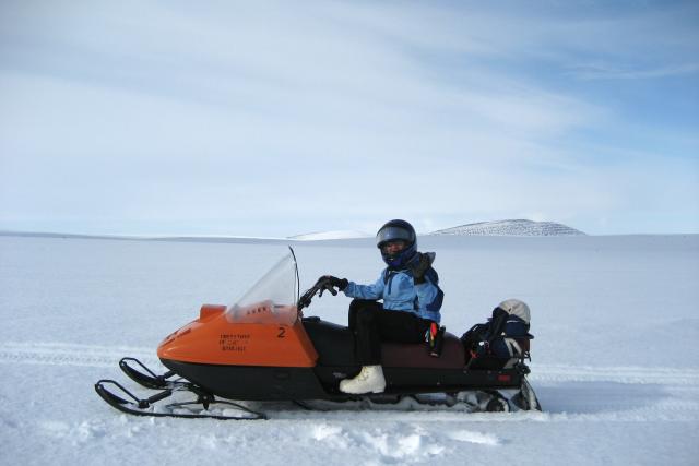 Dr. Jessica Cherry on a snowmachine in Alaska